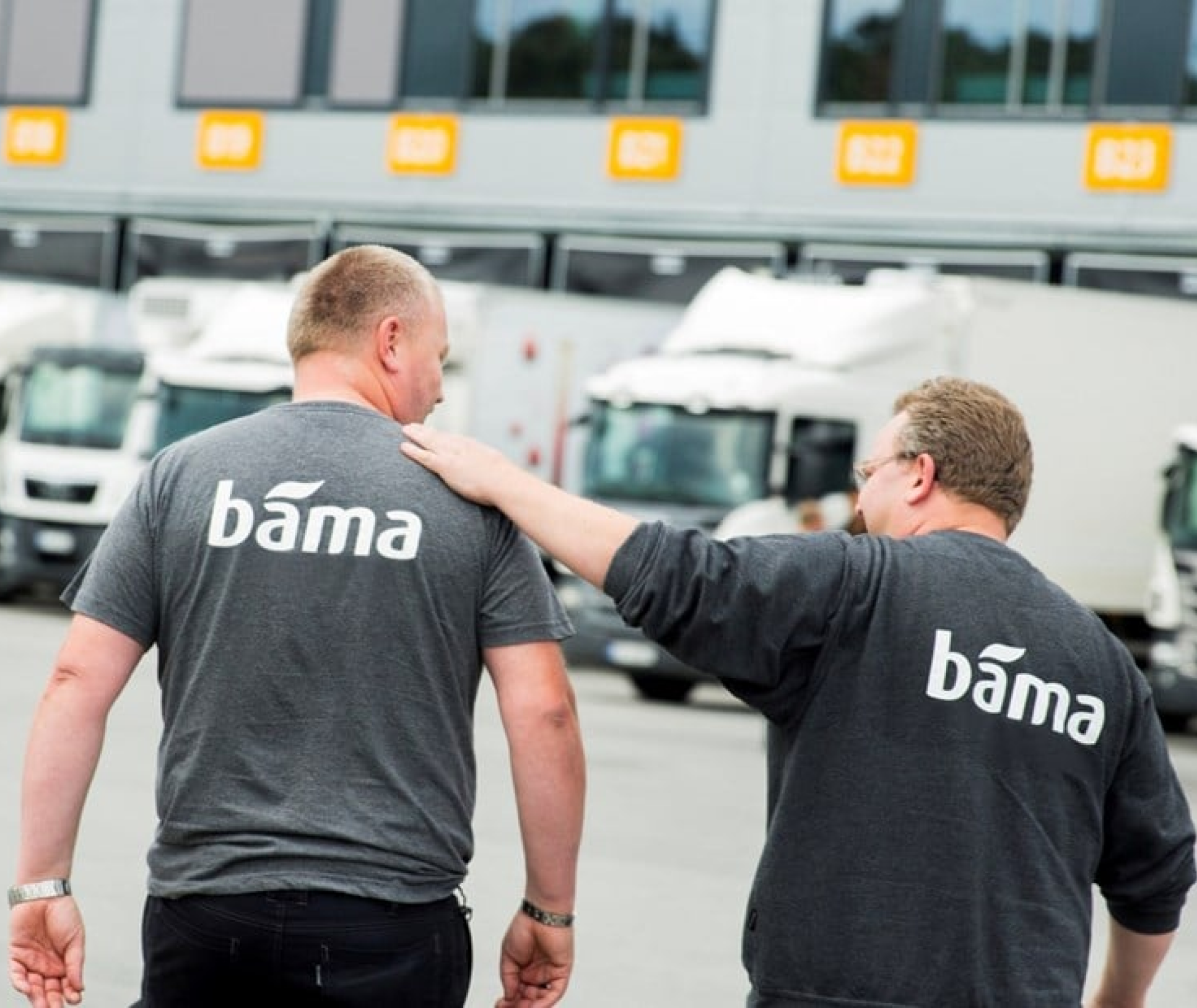 two BAMA men wearing matching shirts